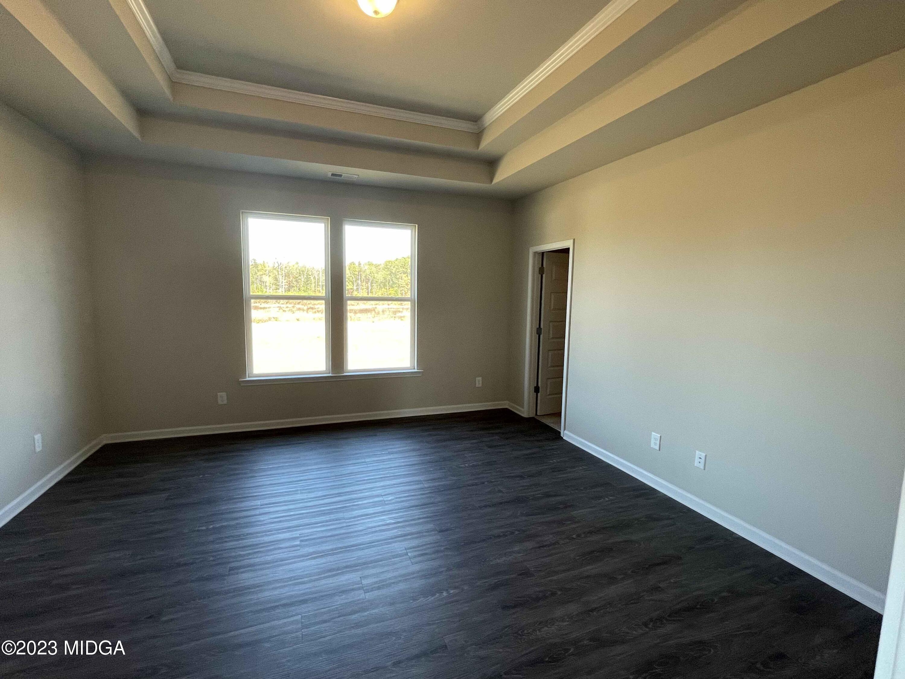 159 Sanders Road Macon, GA 31210 - Photo 24 of 40 a view of an empty room with wooden floor and a window