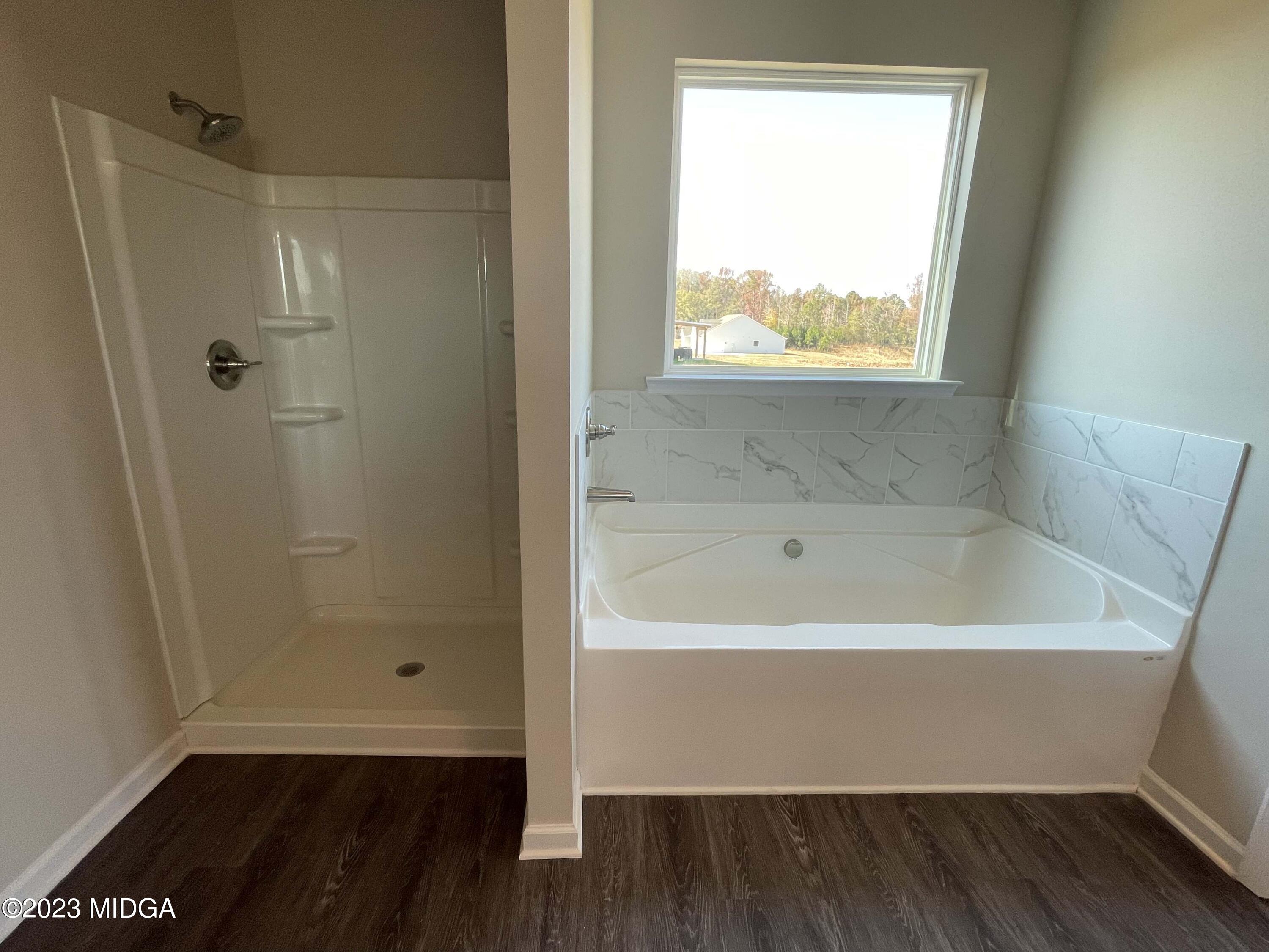 159 Sanders Road Macon, GA 31210 - Photo 26 of 40 a bathroom with a bathtub and window
