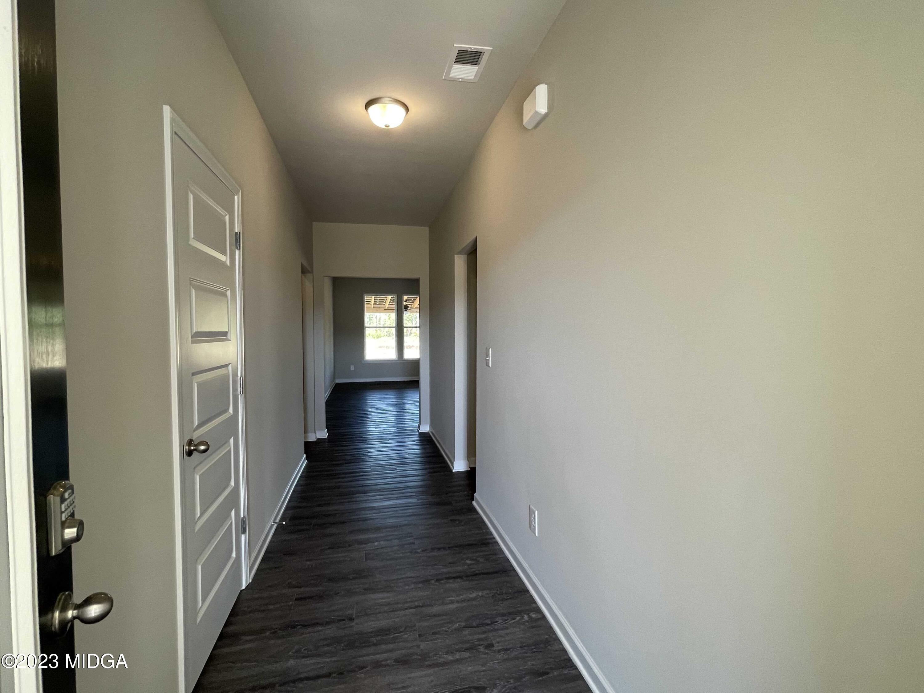 159 Sanders Road Macon, GA 31210 - Photo 5 of 40 a view of a hallway with wooden floor