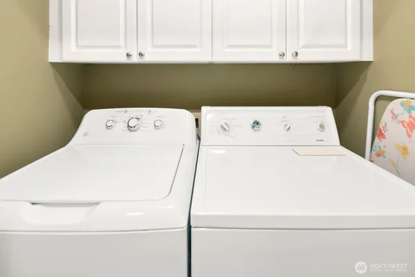 a view of a balcony with chairs and a potted plant