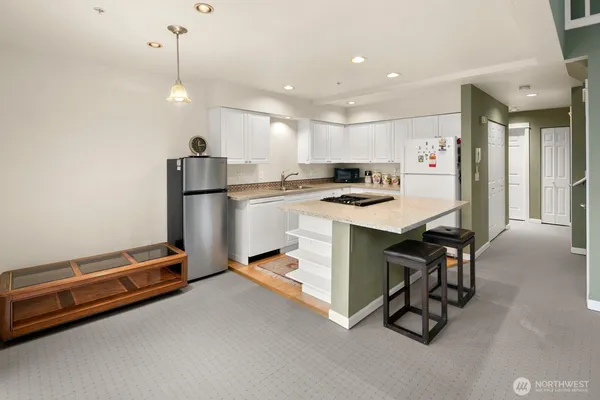 a kitchen with a refrigerator a oven and a sink