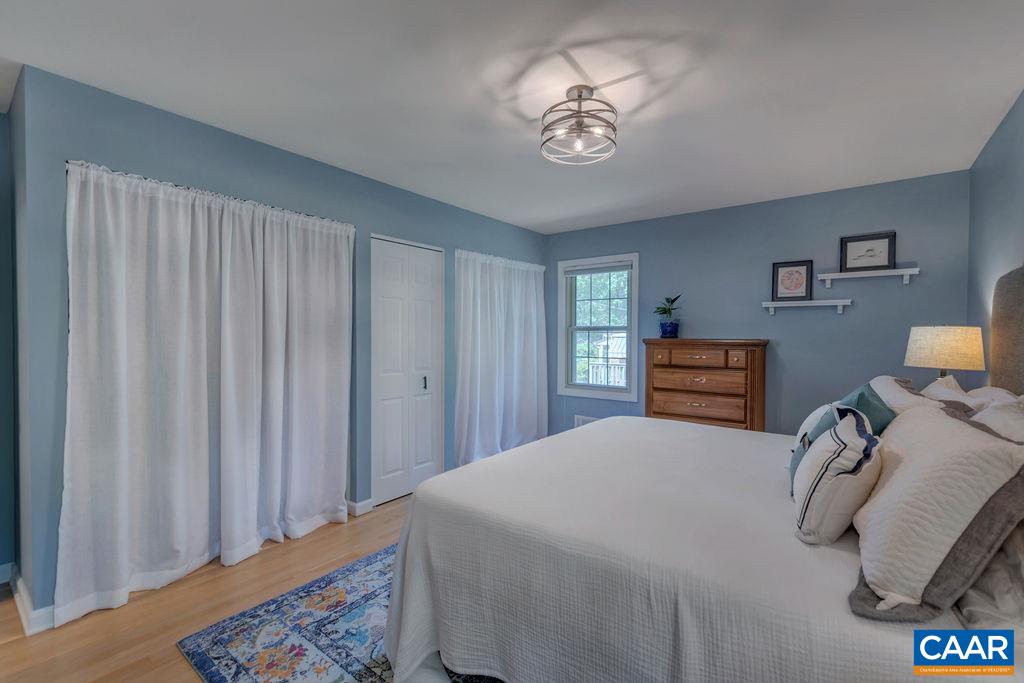 102 Elkhorn Road Charlottesville, VA 22903 - Photo 35 of 73 a bedroom with a bed and a chandelier