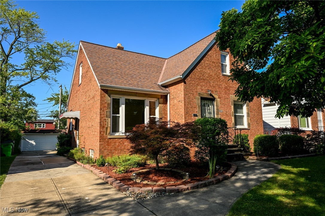 View of front of house featuring an outdoor structure and a garage