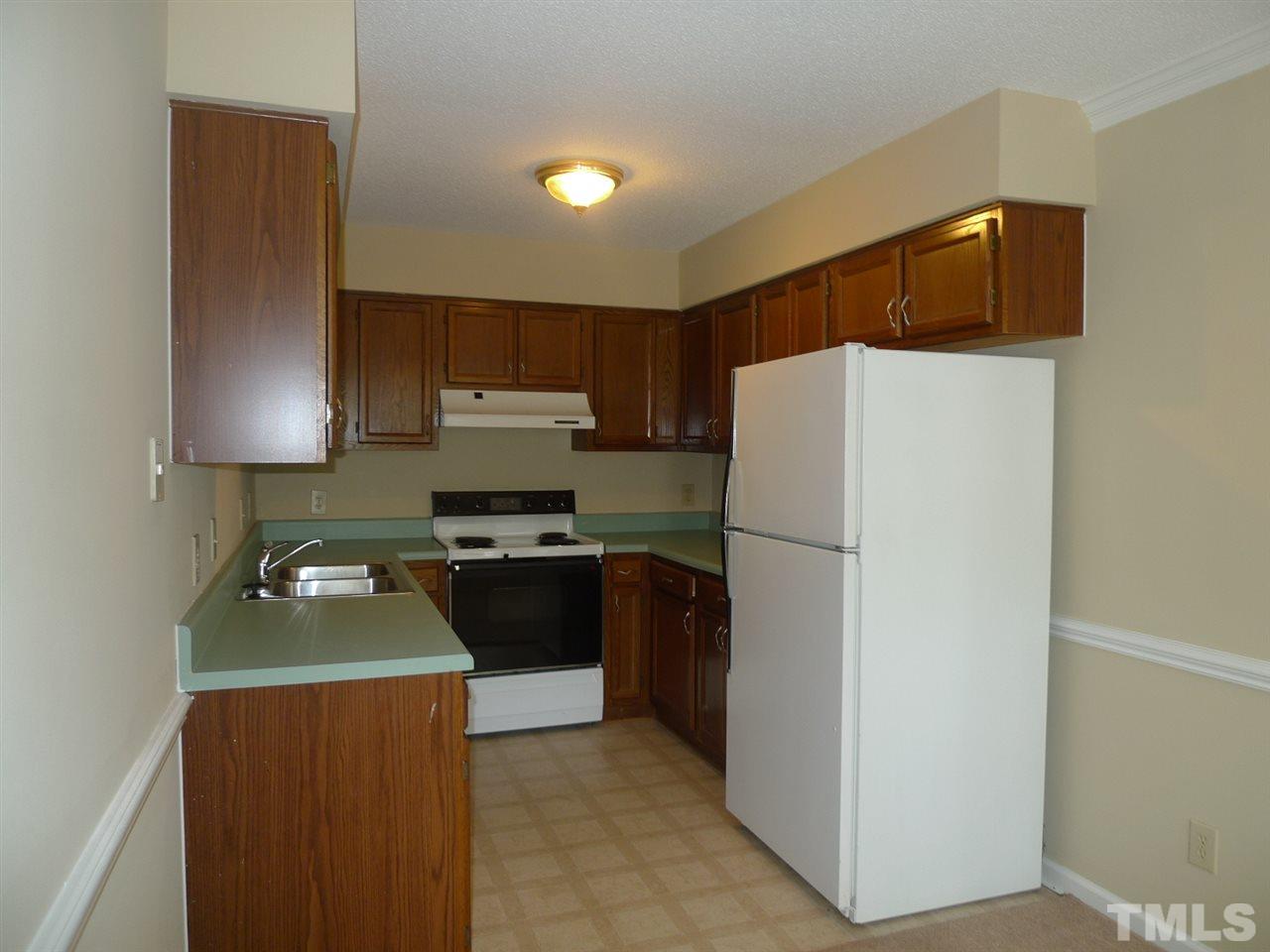1004 Oak Lake Court Raleigh, NC 27606 - Photo 4 of 9 a kitchen with a refrigerator and a stove