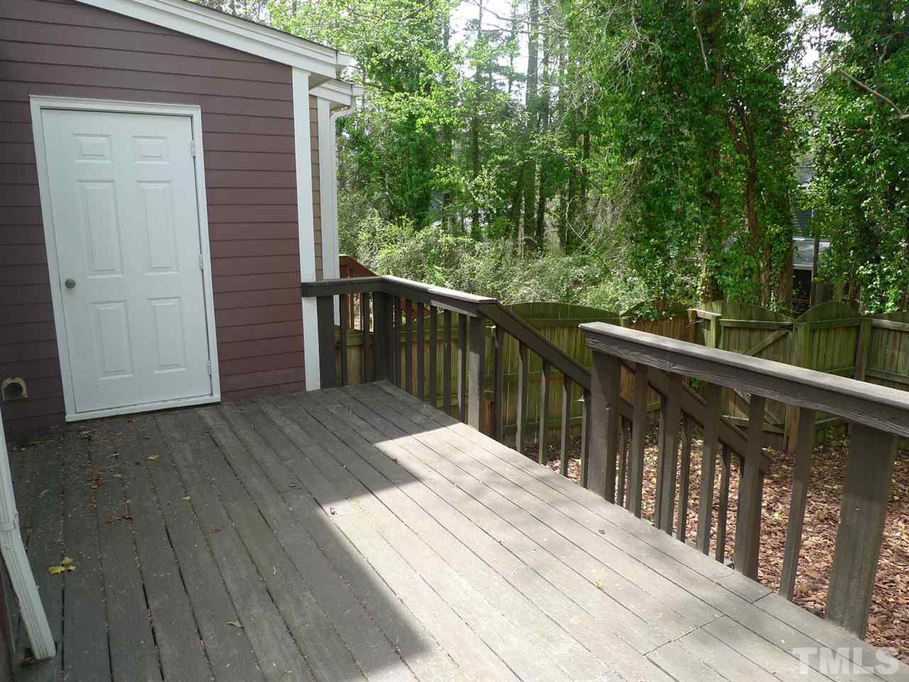 1004 Oak Lake Court Raleigh, NC 27606 - Photo 8 of 9 a balcony with wooden floor and fence