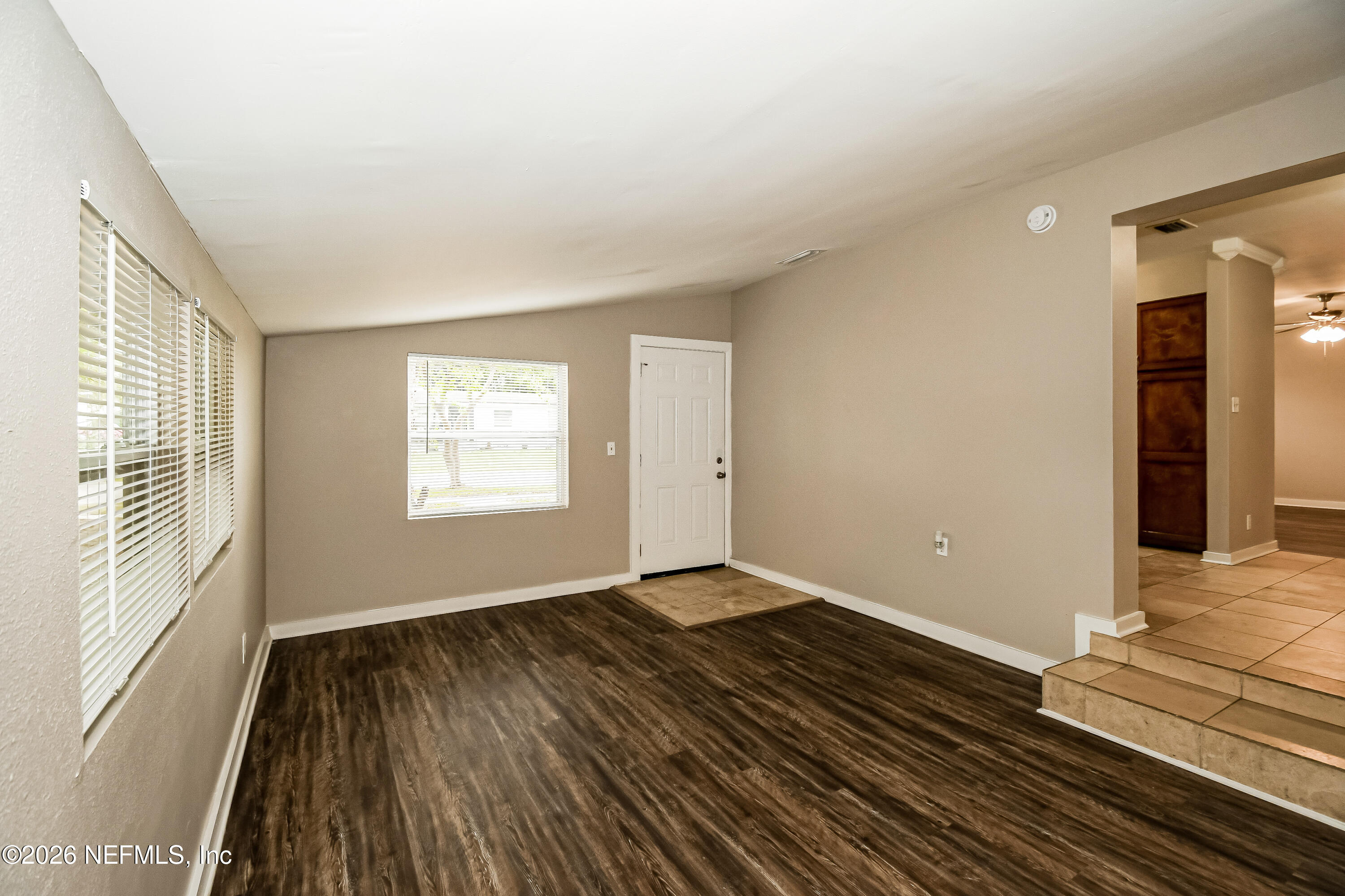 7227 Stonehurst Road North Jacksonville, FL 32277 - Photo 4 of 16 a view of an empty room with wooden floor and a window