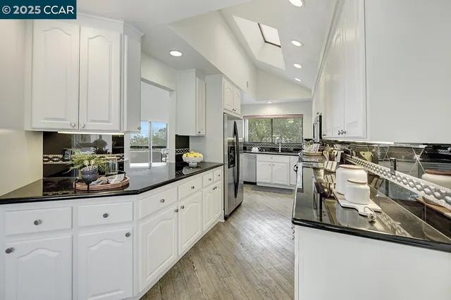 a kitchen with a sink stove and refrigerator