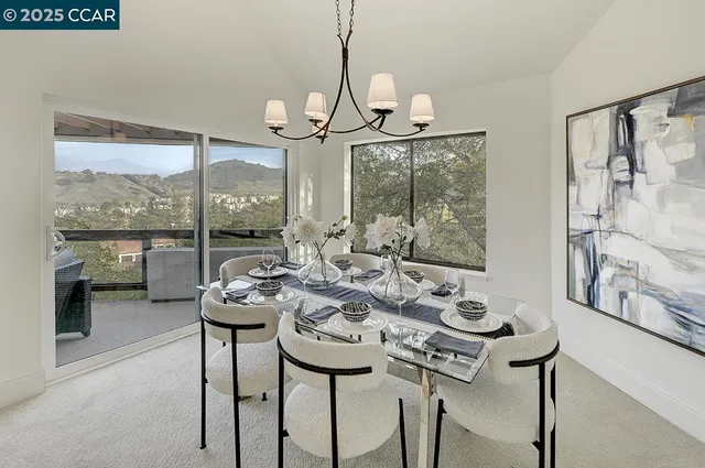 a view of a dining room with furniture large windows and wooden floor