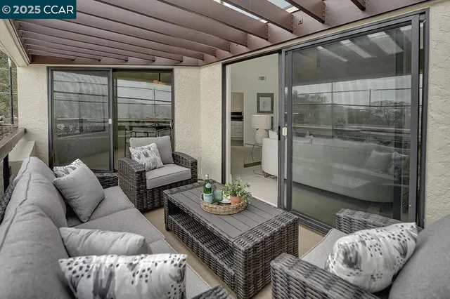 a living room with furniture and a glass door