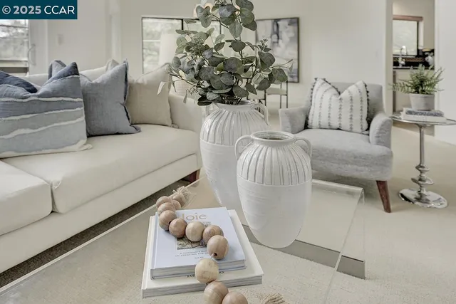 a living room with furniture and flowers