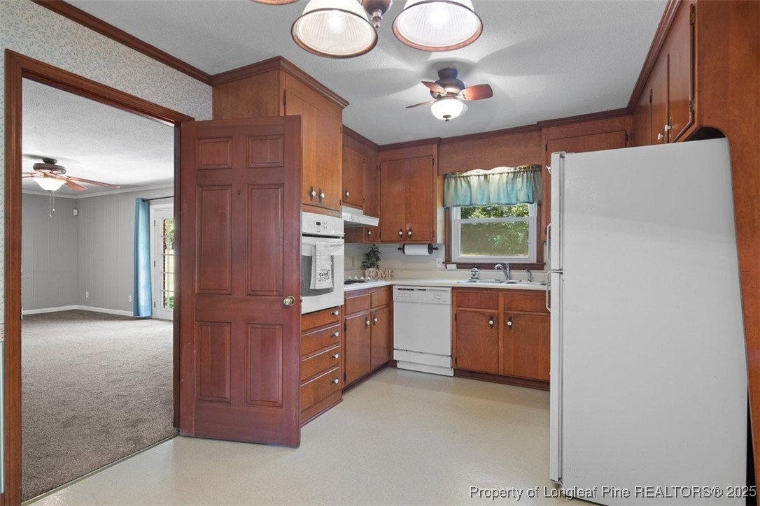2434 North Bragg Boulevard Spring Lake, NC 28390 - Photo 11 of 44 a kitchen with cabinets a sink and dishwasher a large window