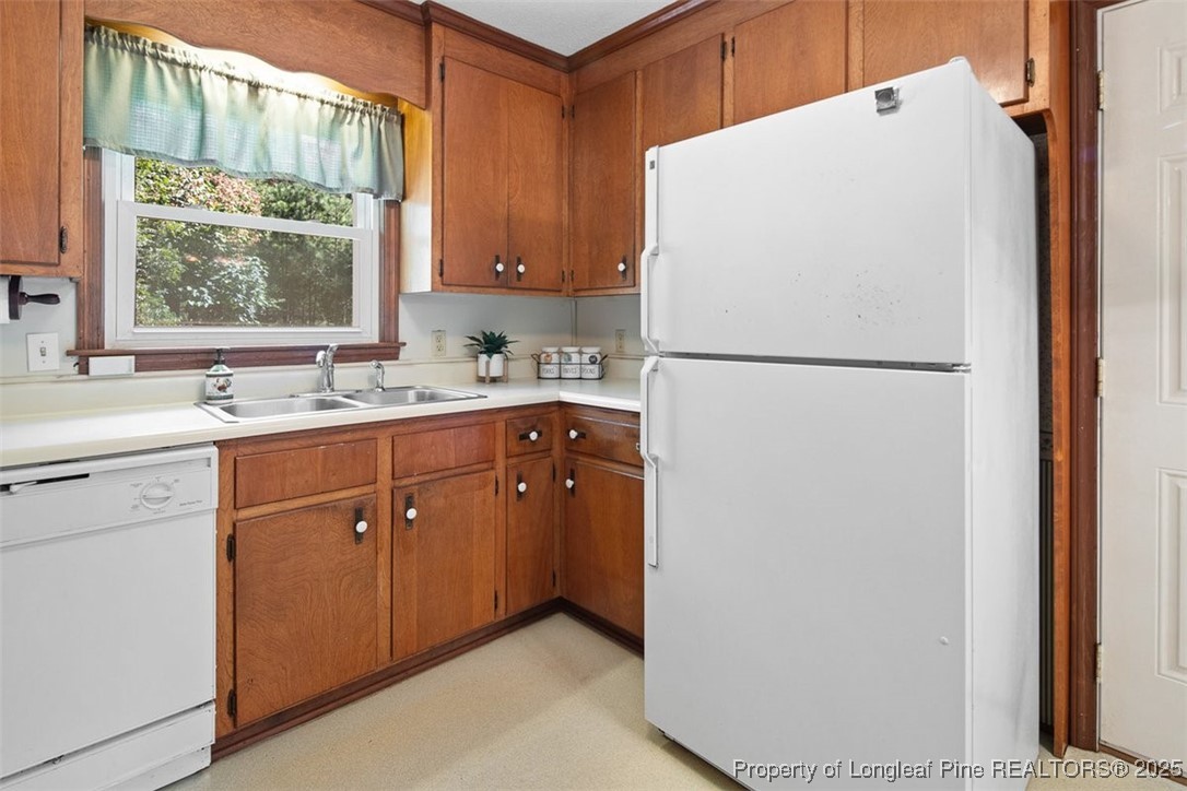 2434 North Bragg Boulevard Spring Lake, NC 28390 - Photo 14 of 44 a white refrigerator freezer sitting inside of a kitchen