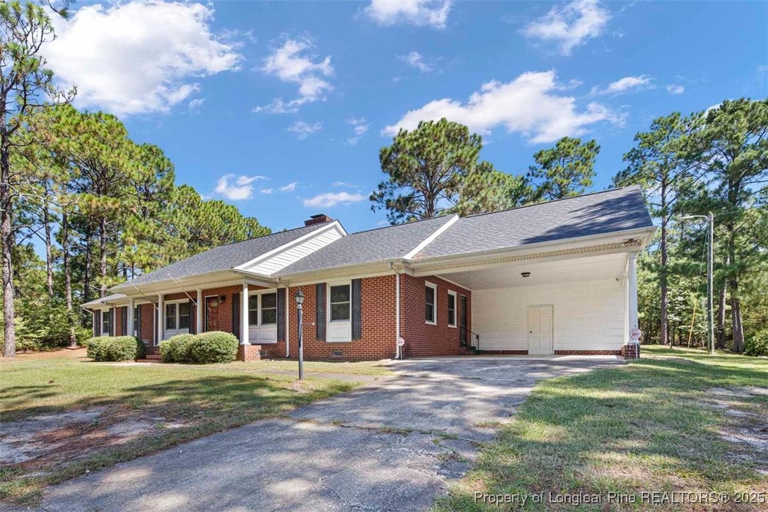2434 North Bragg Boulevard Spring Lake, NC 28390 - Photo 2 of 44 a view of a yard in front of a house with large trees
