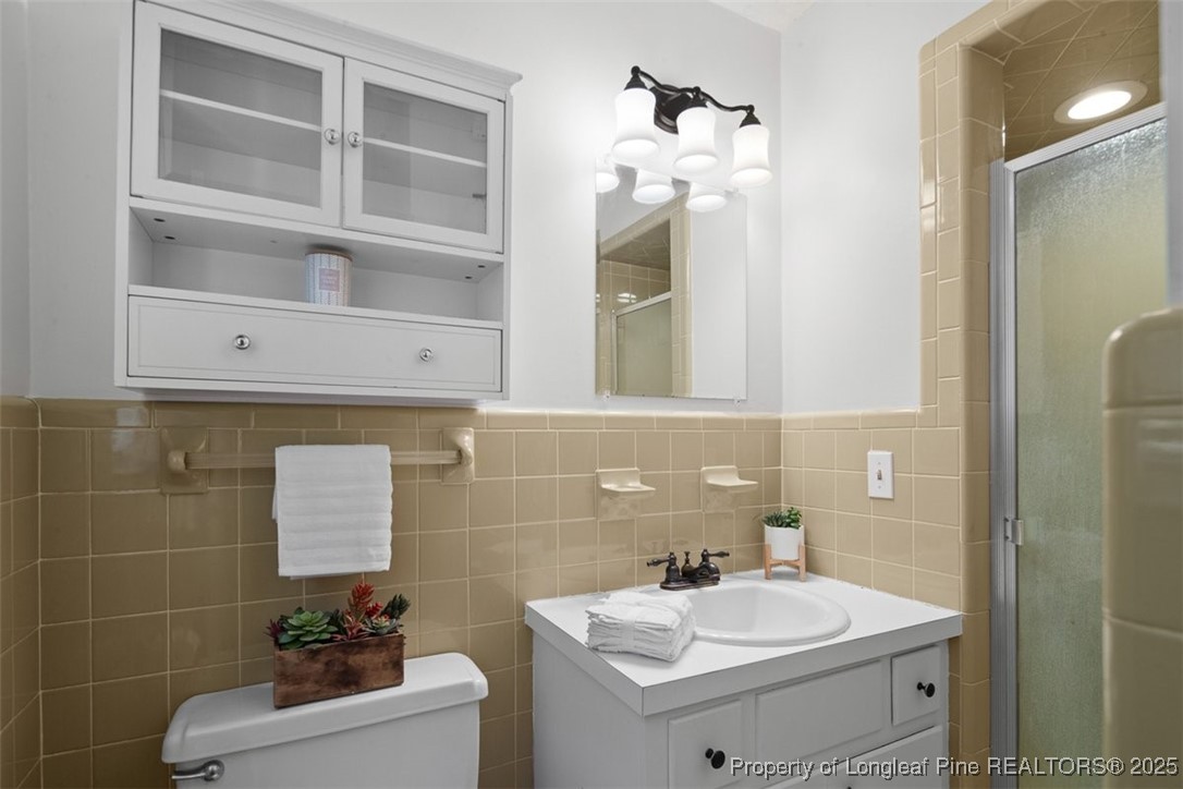 2434 North Bragg Boulevard Spring Lake, NC 28390 - Photo 26 of 44 a bathroom with a sink a toilet and shower