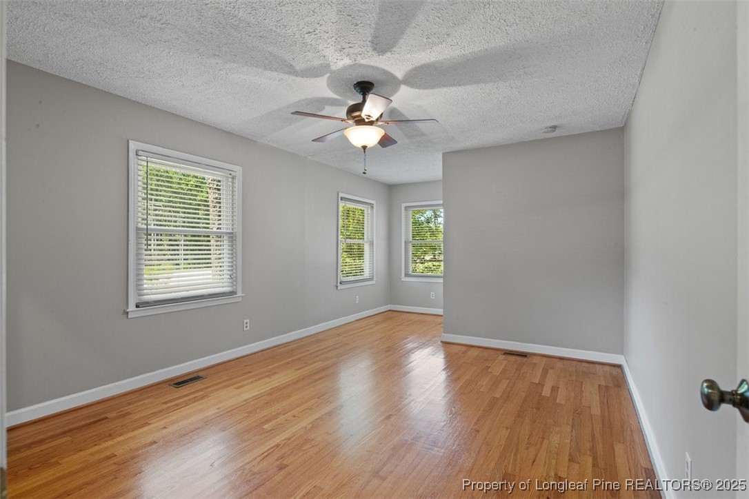 2434 North Bragg Boulevard Spring Lake, NC 28390 - Photo 28 of 44 wooden floor in an empty room with a window