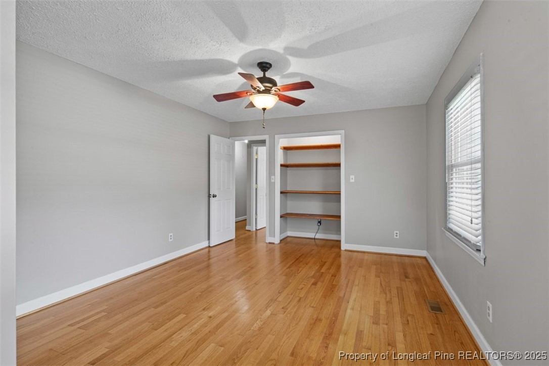 2434 North Bragg Boulevard Spring Lake, NC 28390 - Photo 29 of 44 wooden floor in an empty room with a window