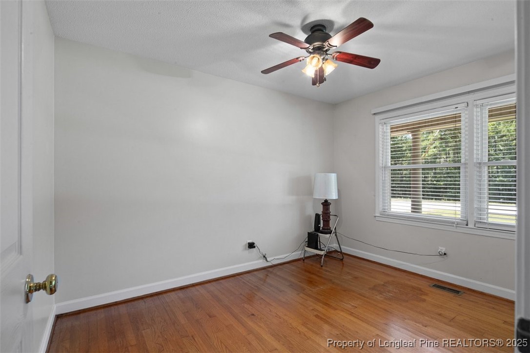 2434 North Bragg Boulevard Spring Lake, NC 28390 - Photo 31 of 44 wooden floor in an empty room with a window