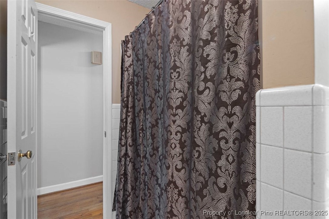 2434 North Bragg Boulevard Spring Lake, NC 28390 - Photo 35 of 44 a bathroom with a shower curtain and a sink