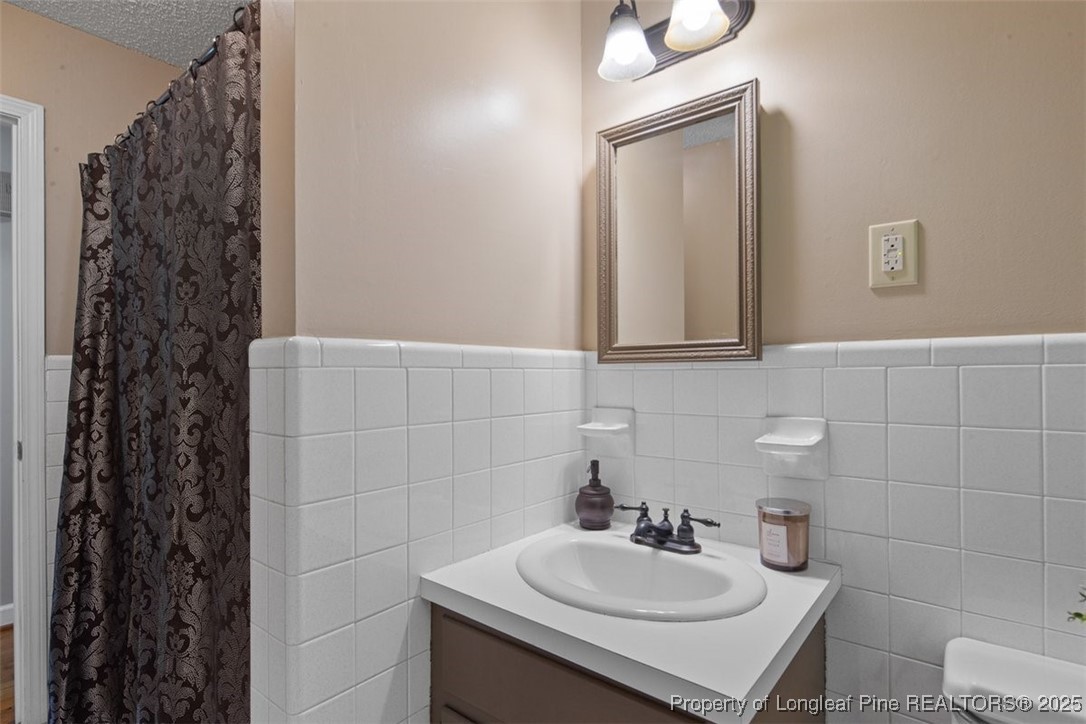 2434 North Bragg Boulevard Spring Lake, NC 28390 - Photo 36 of 44 a bathroom with a sink a toilet and shower
