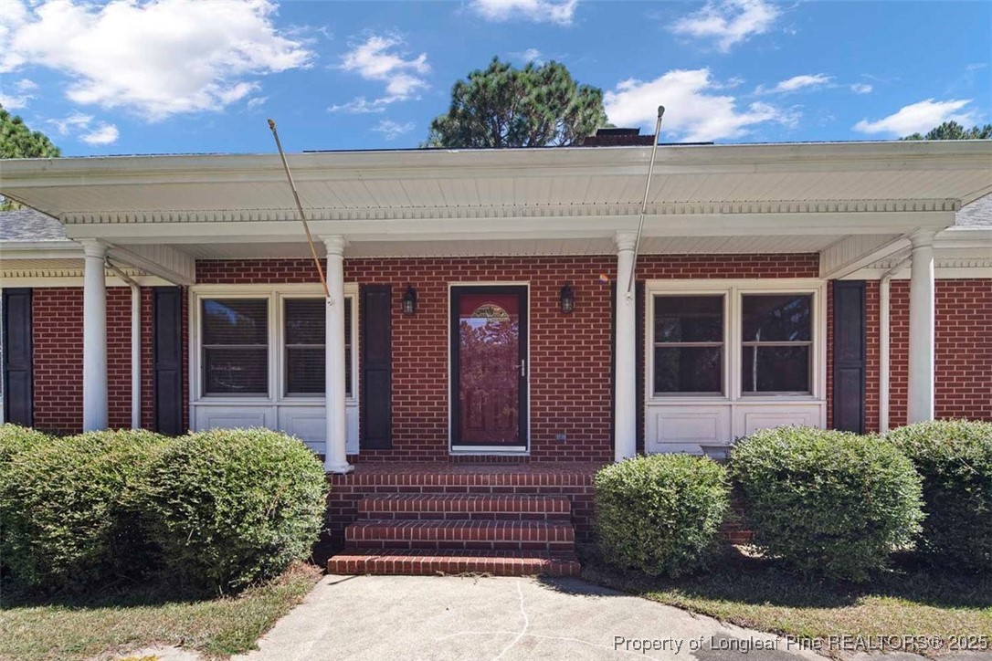 2434 North Bragg Boulevard Spring Lake, NC 28390 - Photo 4 of 44 front view of a brick house with a large window