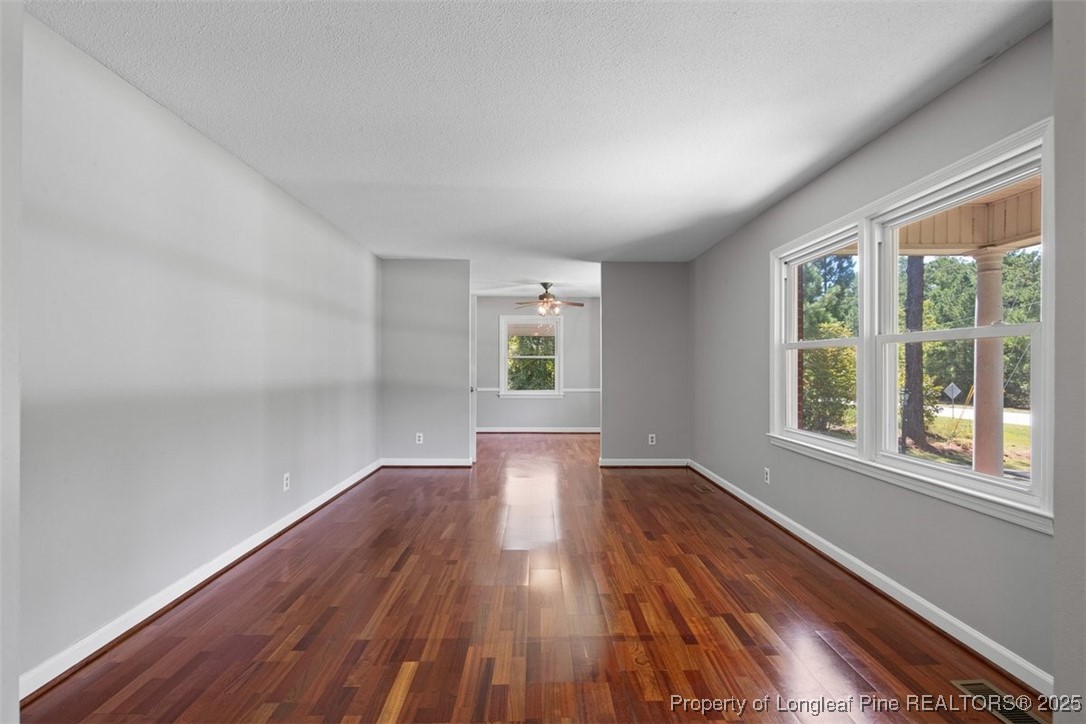 2434 North Bragg Boulevard Spring Lake, NC 28390 - Photo 6 of 44 a view of an empty room with wooden floor and a window