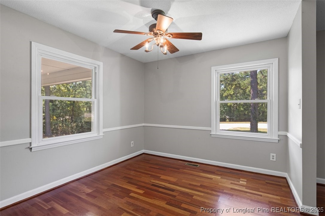 2434 North Bragg Boulevard Spring Lake, NC 28390 - Photo 8 of 44 a view of an empty room with wooden floor and a window