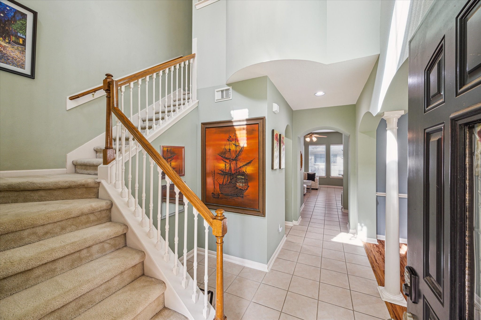 2403 Clippers Square Houston, TX 77058 - Photo 3 of 20 a view of staircase with lots of frames on wall and a large window