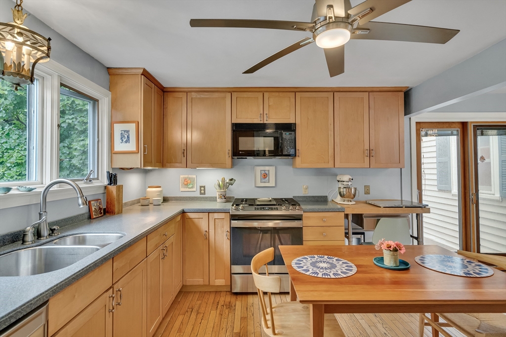 299 Albemarle Road Newton, MA 02460 - Photo 10 of 32 a kitchen with a sink a stove and cabinets