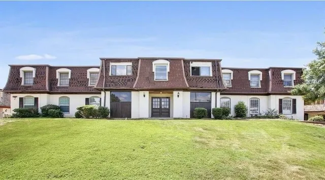 a front view of building with yard