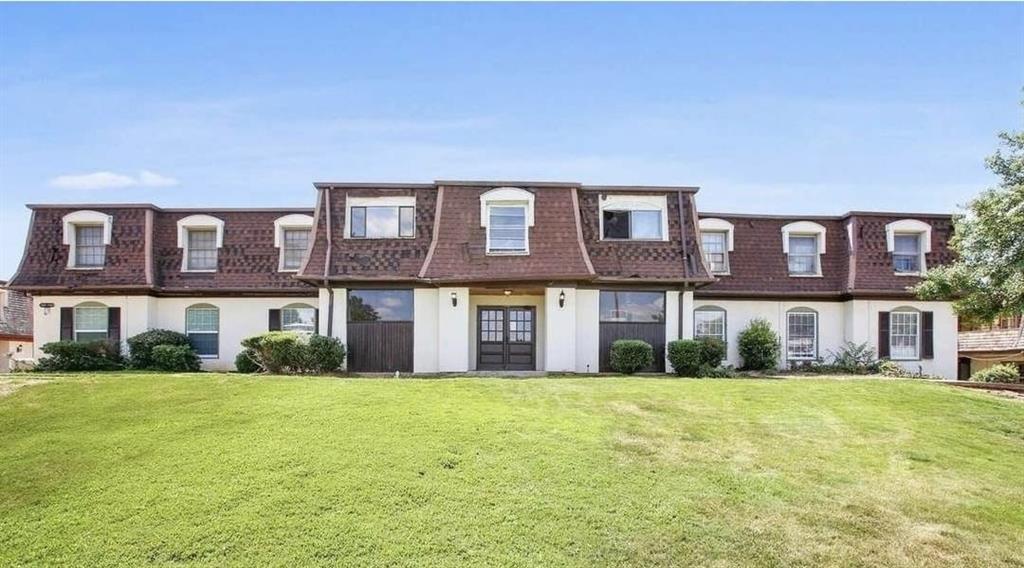 a front view of building with yard