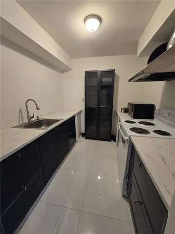 a kitchen with a sink and a stove top oven