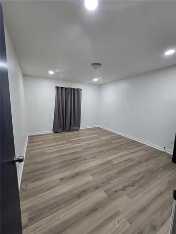 an empty room with wooden floor