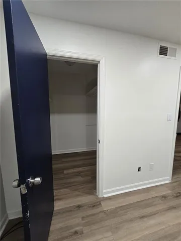 an empty room with wooden floor