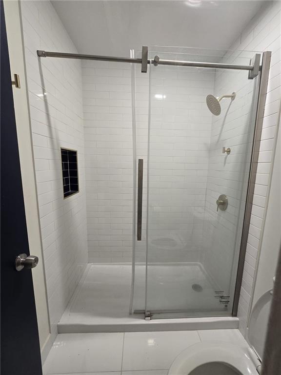 177 Rue Fontaine, Unit 2 Stonecrest, GA 30038 - Photo 7 of 7 a bathroom with a glass shower door