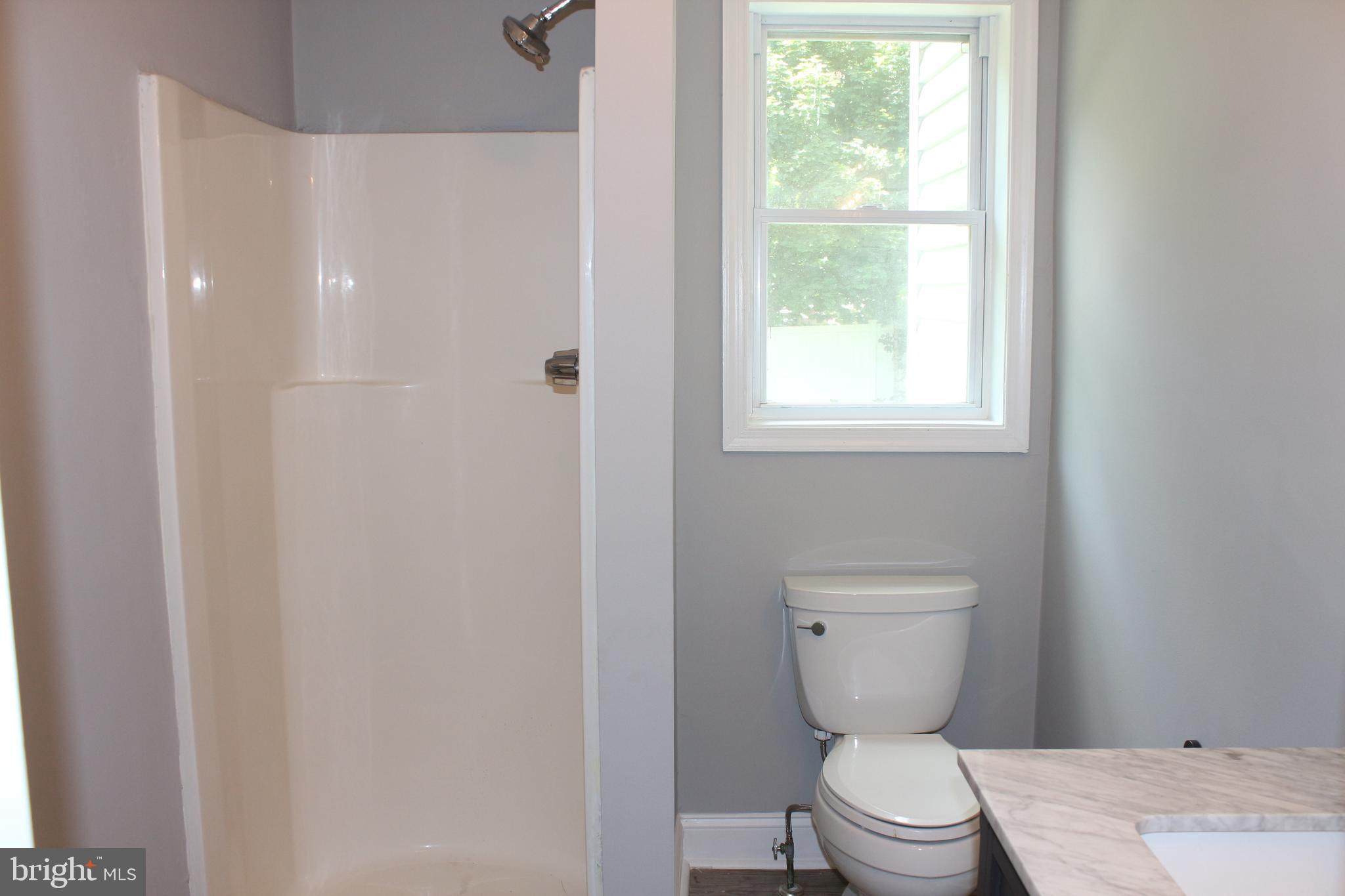 25 Church Street Glassboro, NJ 08028 - Photo 15 of 21 a bathroom with a toilet and a window