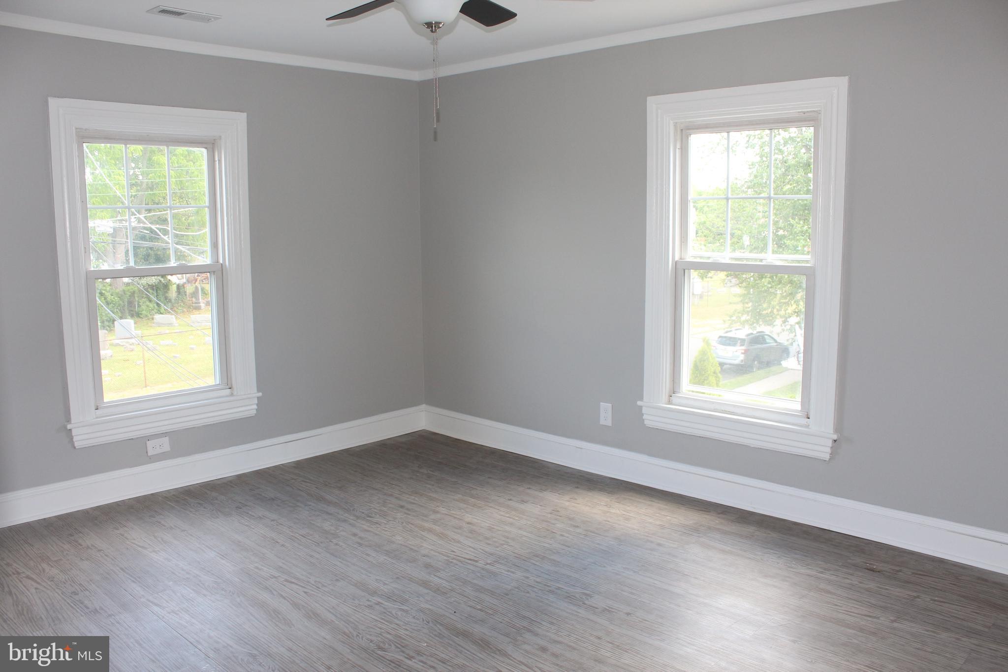 25 Church Street Glassboro, NJ 08028 - Photo 18 of 21 a view of an empty room with wooden floor and a window