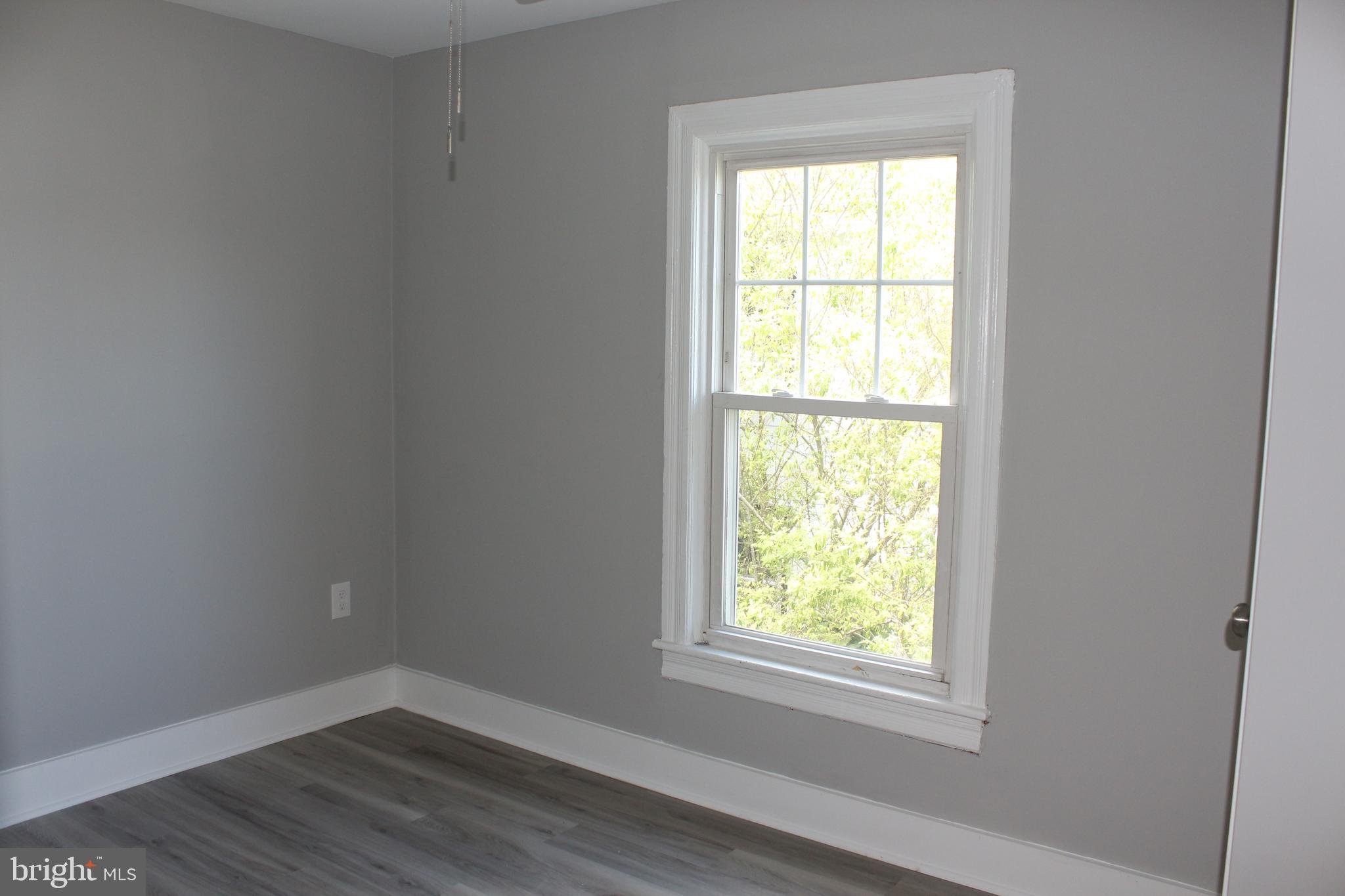25 Church Street Glassboro, NJ 08028 - Photo 20 of 21 a view of an empty room with wooden floor and a window