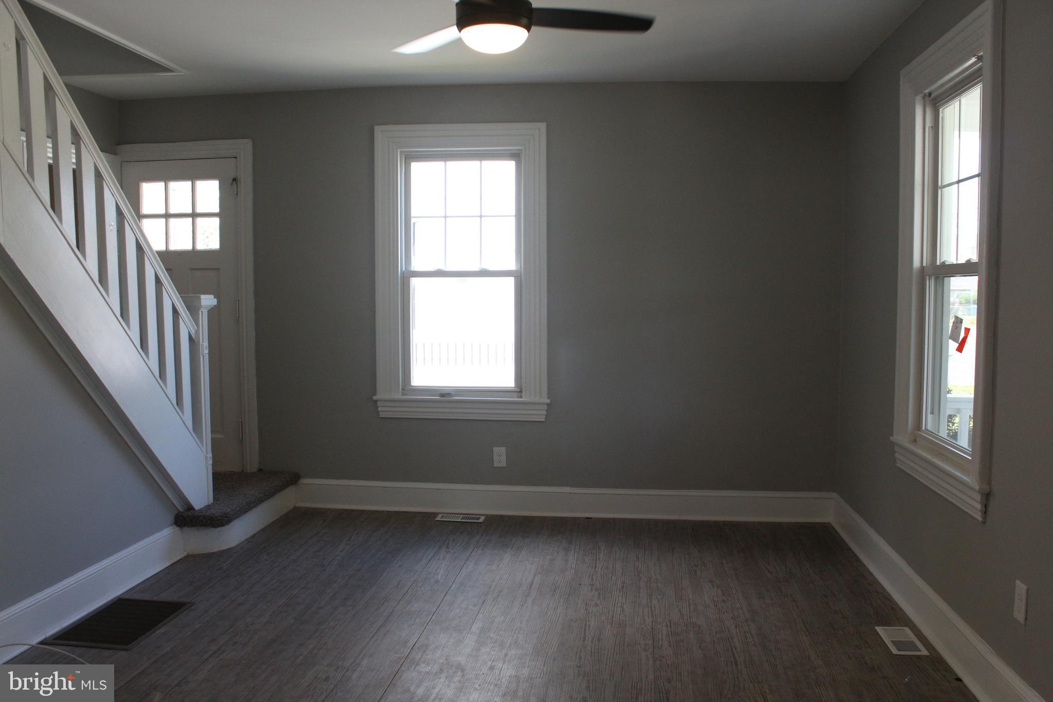 25 Church Street Glassboro, NJ 08028 - Photo 7 of 21 an empty room with wooden floor and windows