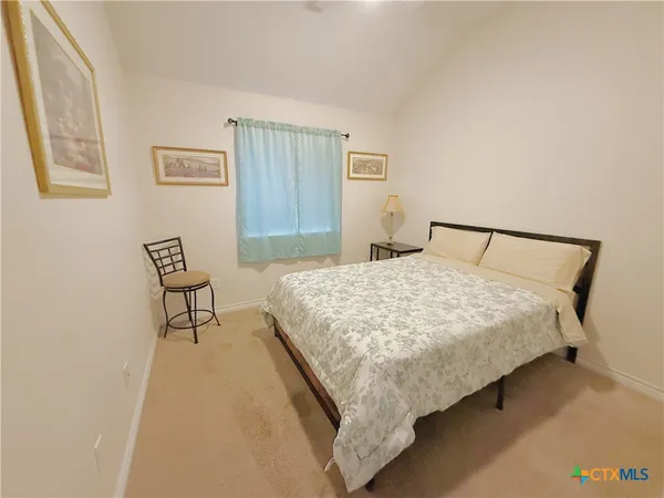 a bedroom with a bed and a lamp with window