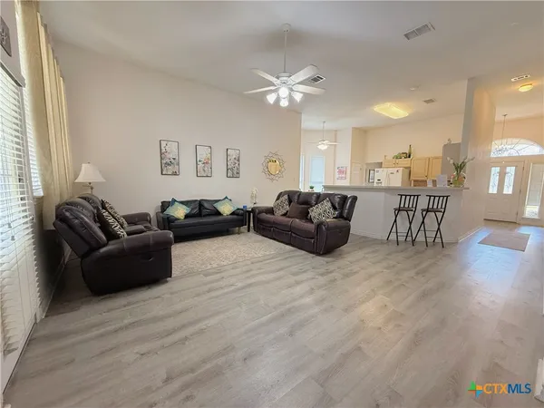 a living room with furniture and a wooden floor