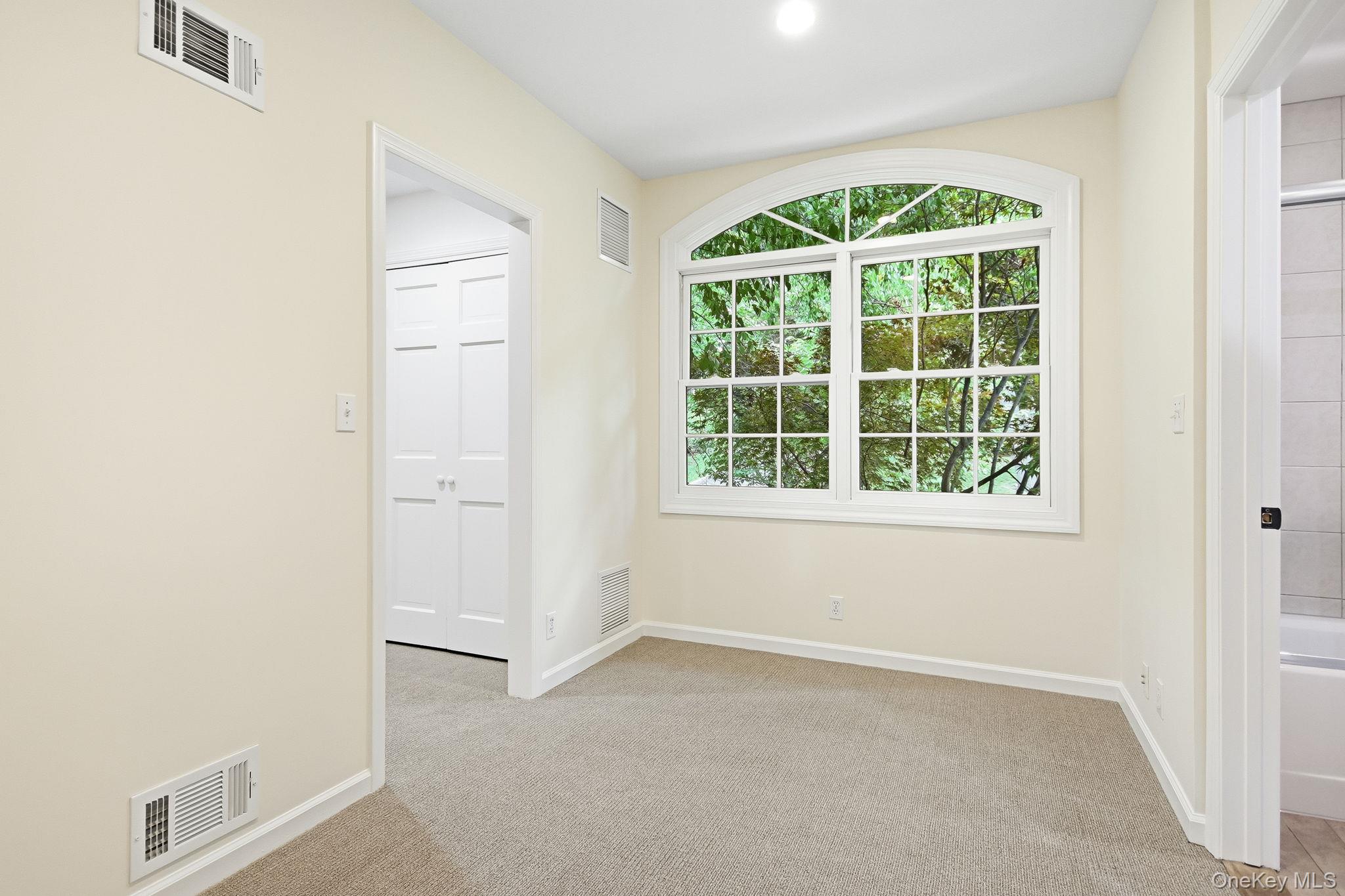 26 Century Ridge Road Purchase, NY 10577 - Photo 19 of 50 Second en-suite (same split level up) featuring a sitting room; arched window with grid panes overlooking lush greenery