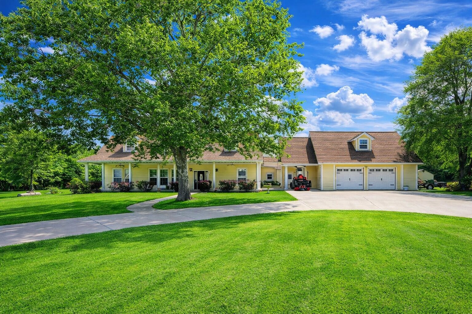 a front view of a house with a yard and trees