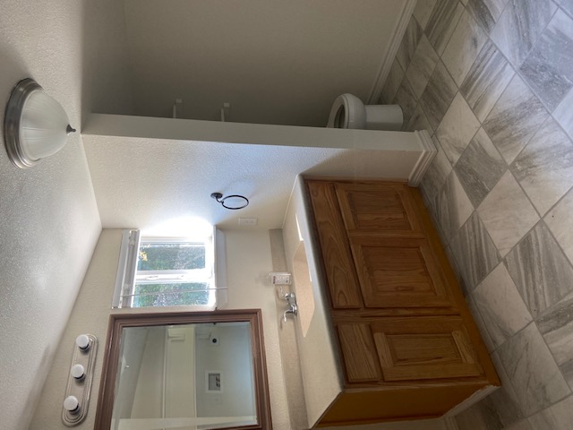 823 Monterrey Street Lockhart, TX 78644 - Photo 8 of 14 a spacious bathroom with a sink a toilet and a mirror