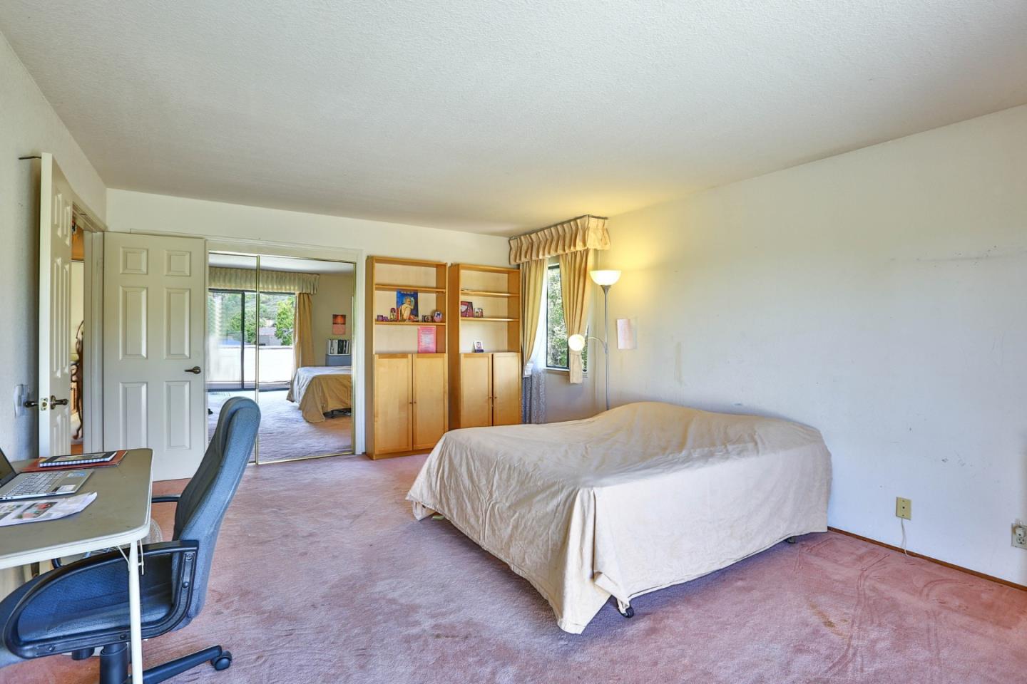 6964 McCall Drive San Jose, CA 95120 - Photo 20 of 57 a spacious bedroom with a bed table and chair