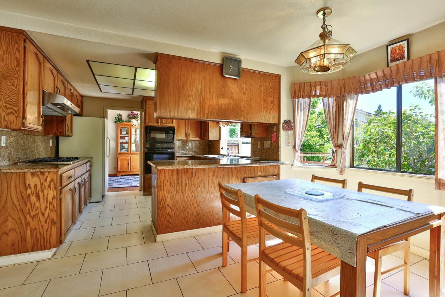 6964 McCall Drive San Jose, CA 95120 - Photo 23 of 57 a dining hall with stainless steel appliances kitchen island granite countertop a sink and cabinets