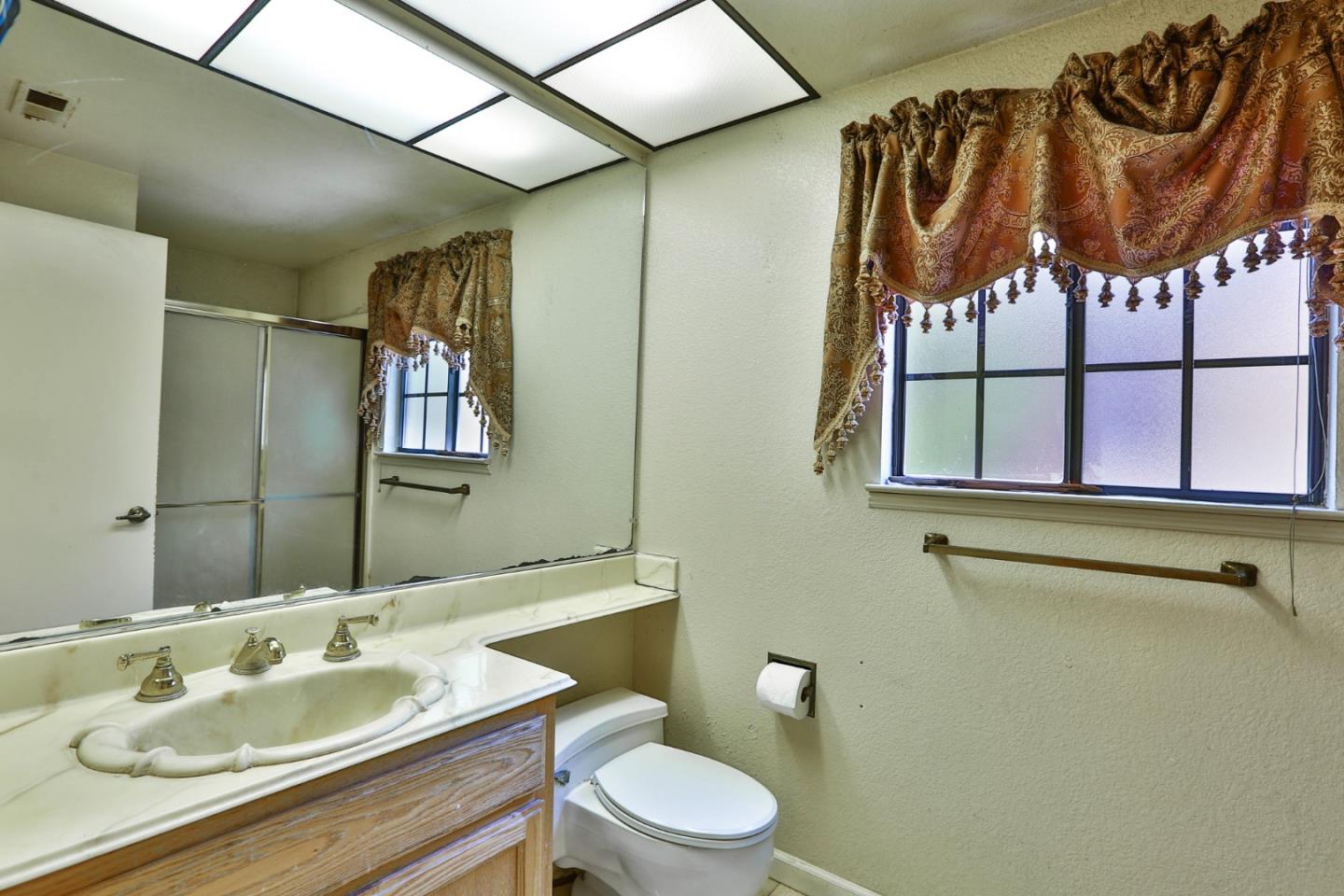 6964 McCall Drive San Jose, CA 95120 - Photo 26 of 57 a bathroom with a sink a toilet and a mirror