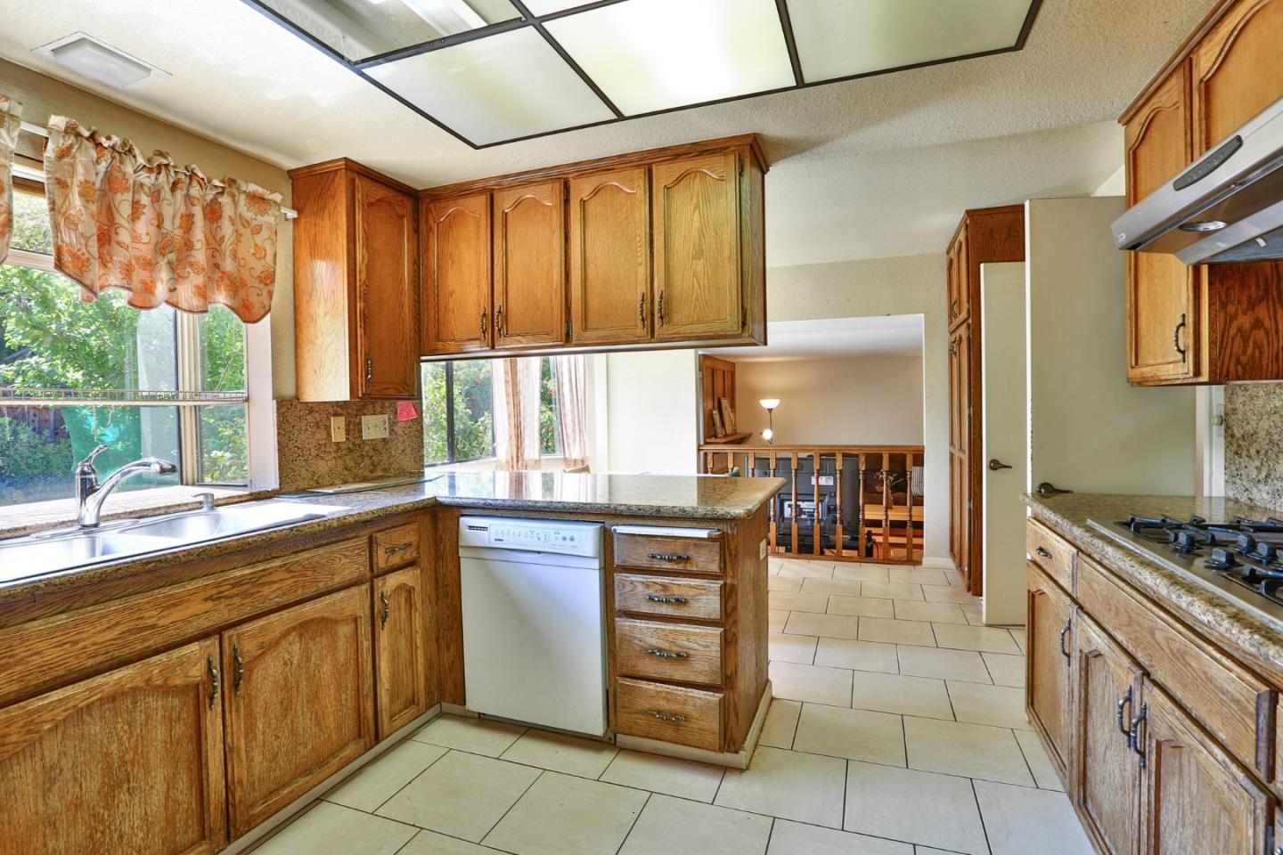 6964 McCall Drive San Jose, CA 95120 - Photo 9 of 57 a kitchen with a stove a sink and a refrigerator