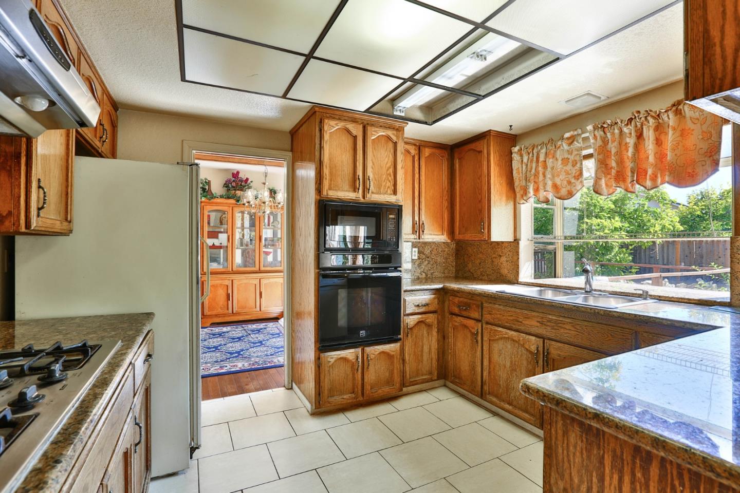 6964 McCall Drive San Jose, CA 95120 - Photo 10 of 57 a kitchen with granite countertop a stove top oven sink and cabinets