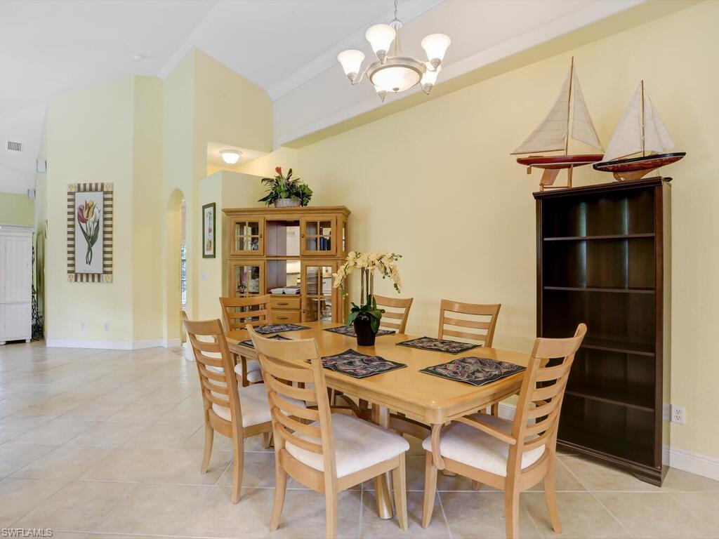 1079 Michigan Avenue Naples, FL 34103 - Photo 16 of 31 a view of a dining room with furniture and a chandelier