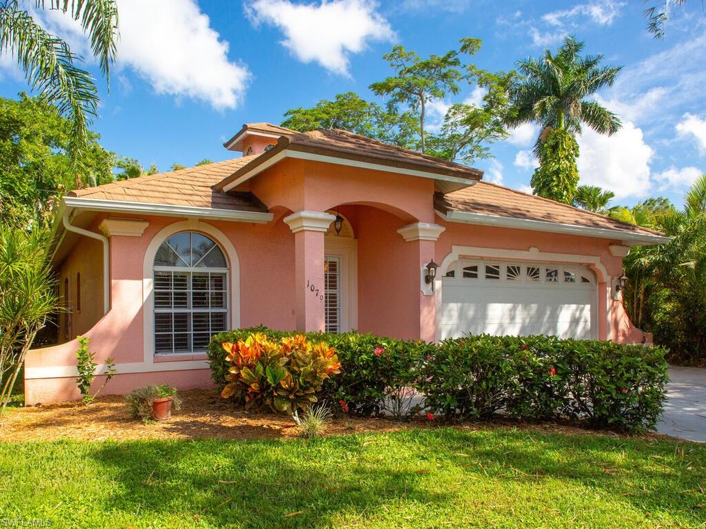 1079 Michigan Avenue Naples, FL 34103 - Photo 2 of 31 front view of a house with a garden